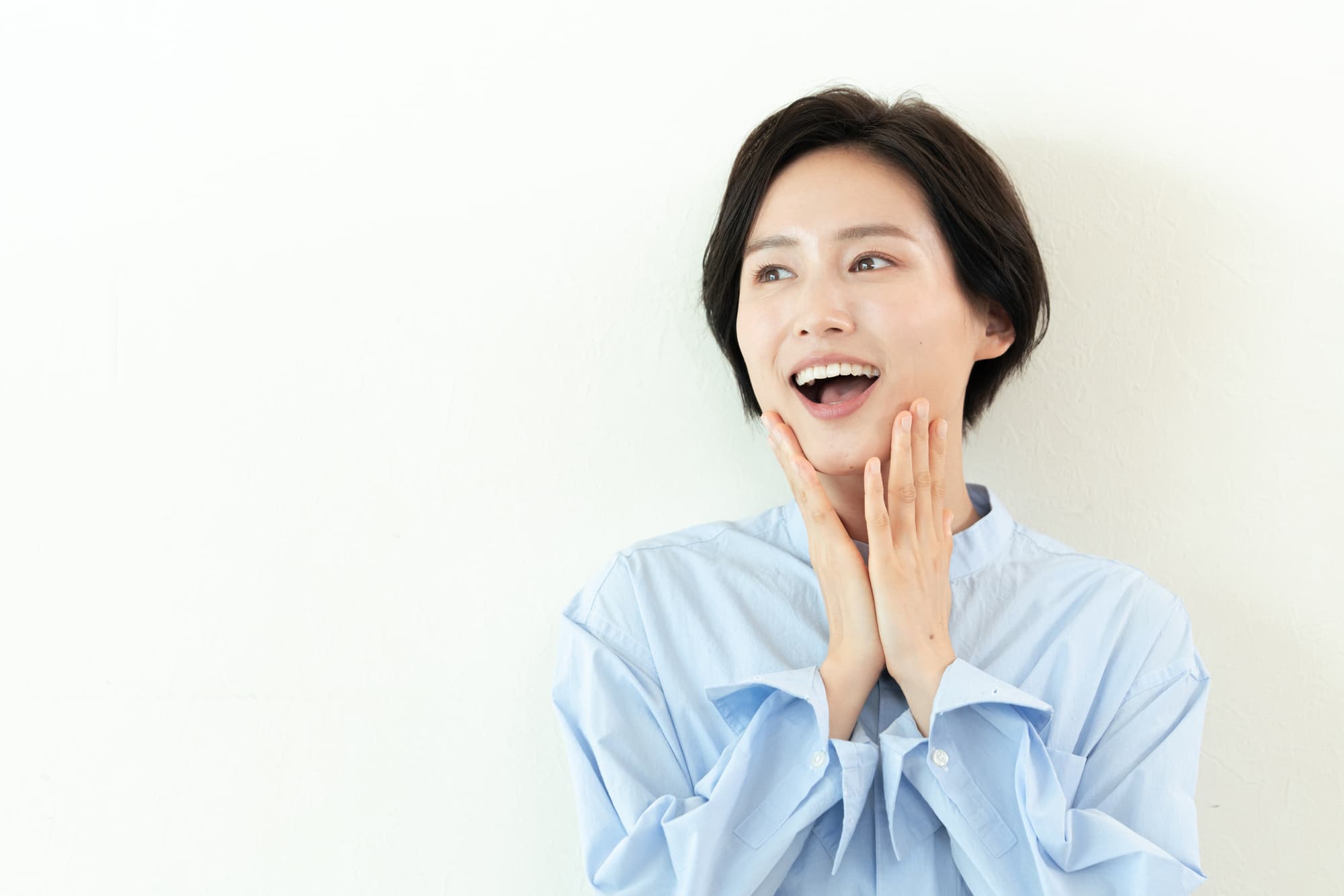 セラミックの歯を見せて笑う女性